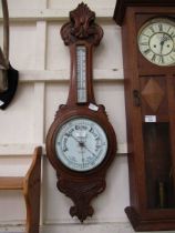 An early 20th century oak aneroid banjo barometer