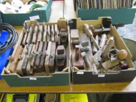 Two trays containing a quantity of moulding planes, brace and bit, block planes, etc