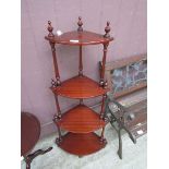 A reproduction mahogany corner four tier whatnot