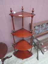 A reproduction mahogany corner four tier whatnot
