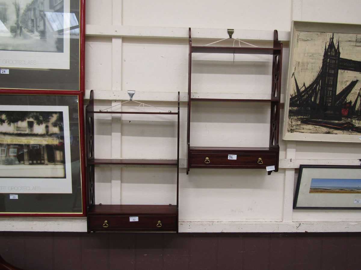 Two reproduction mahogany wall mounted shelving units with drawer