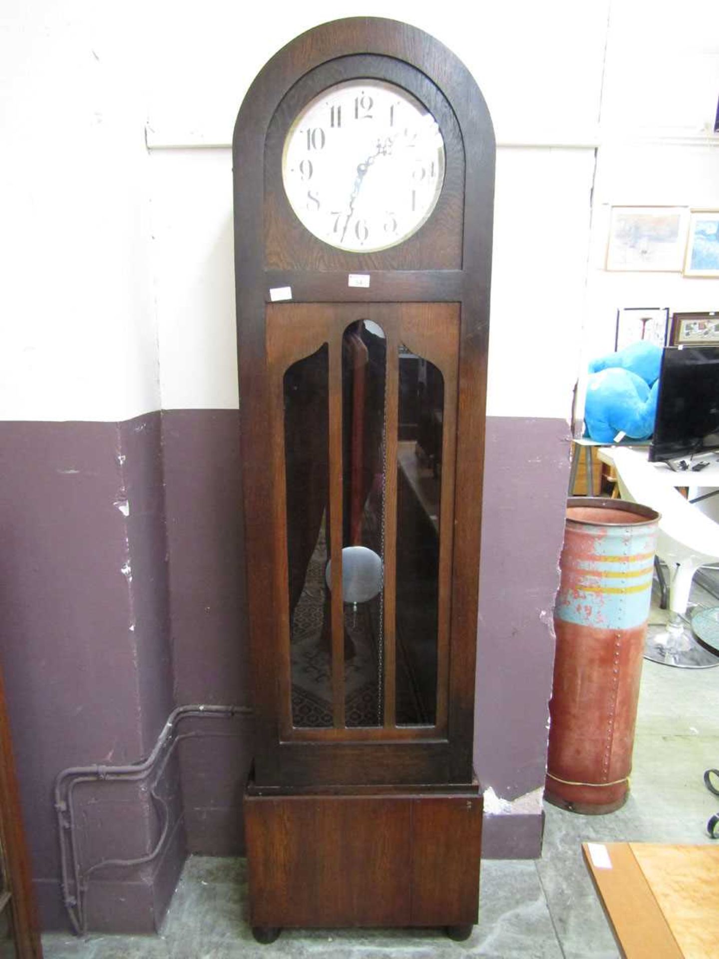 An early 20th century oak dome topped long case clock Unsure of working order, lacking key, advise