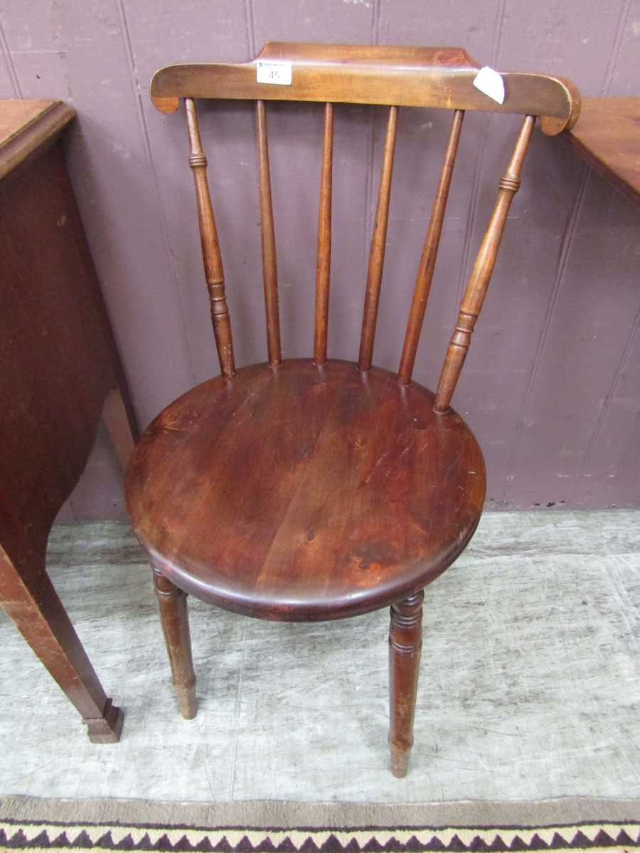 An early 20th century penny seated spindle back chair