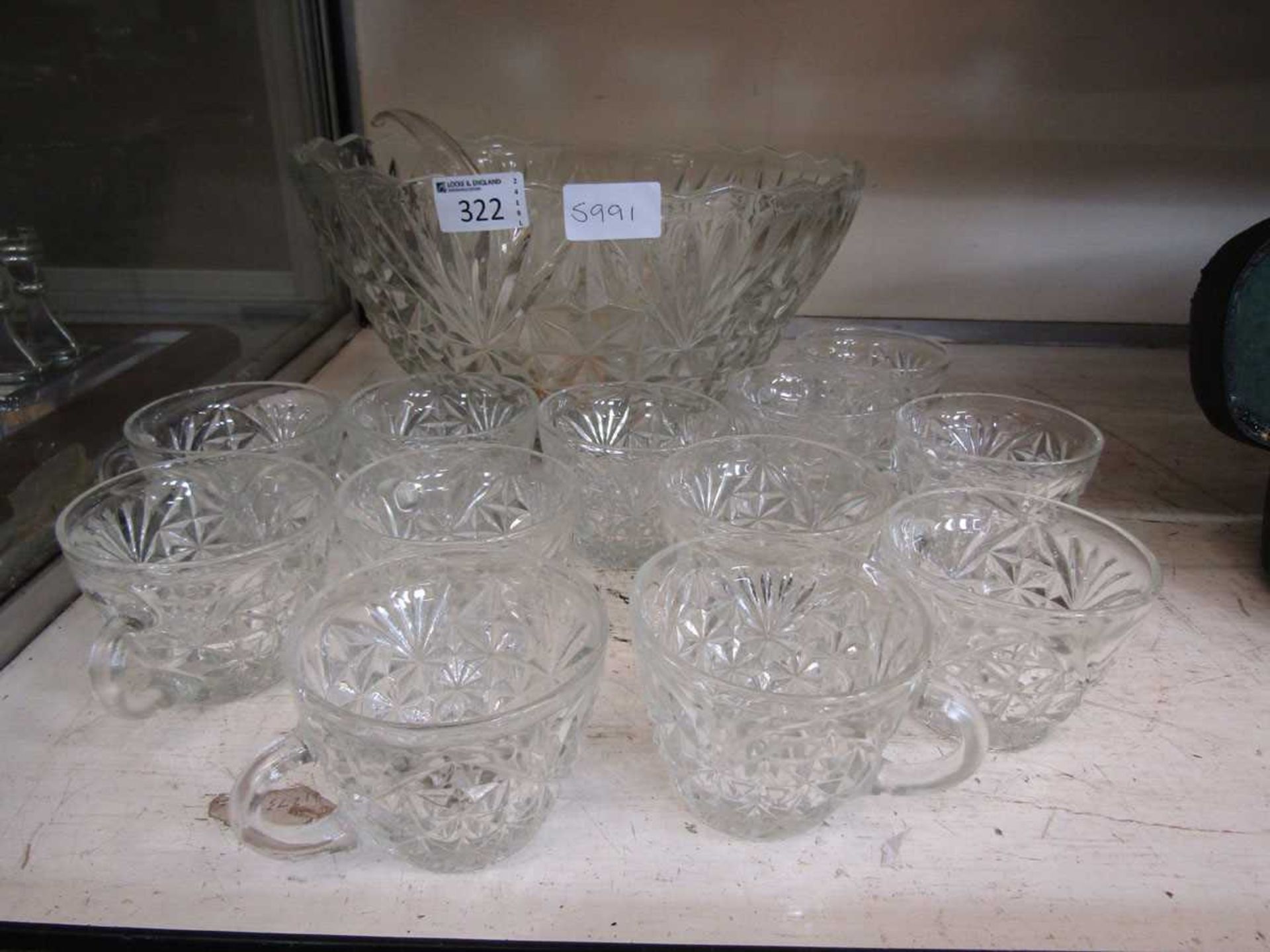 An Arlington Crystal boxed punch bowl set with twelve drinking glasses