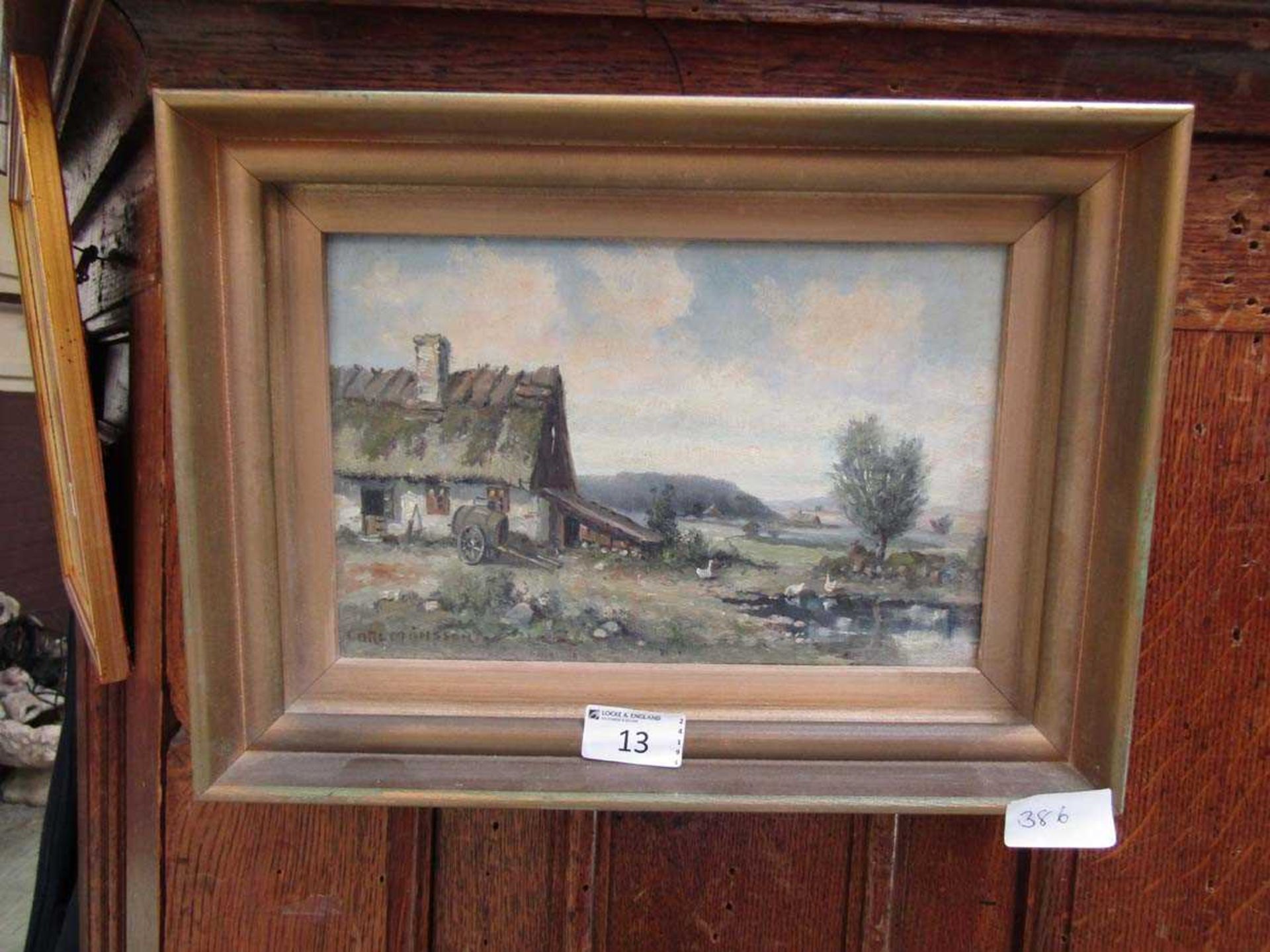 A gilt framed oil on board of country farm scene signed bottom left