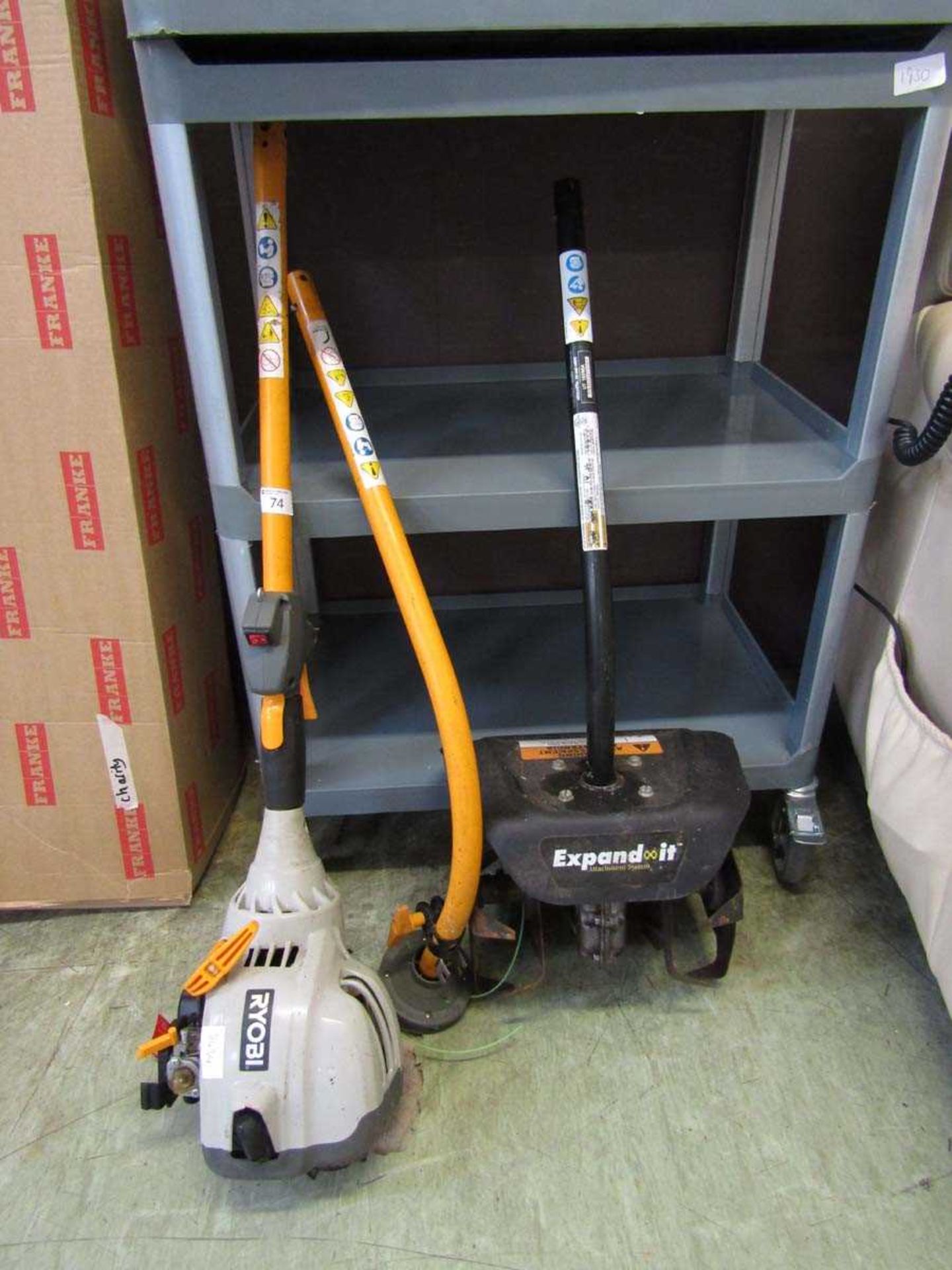 A Ryobi petrol strimmer with attachment rotivator