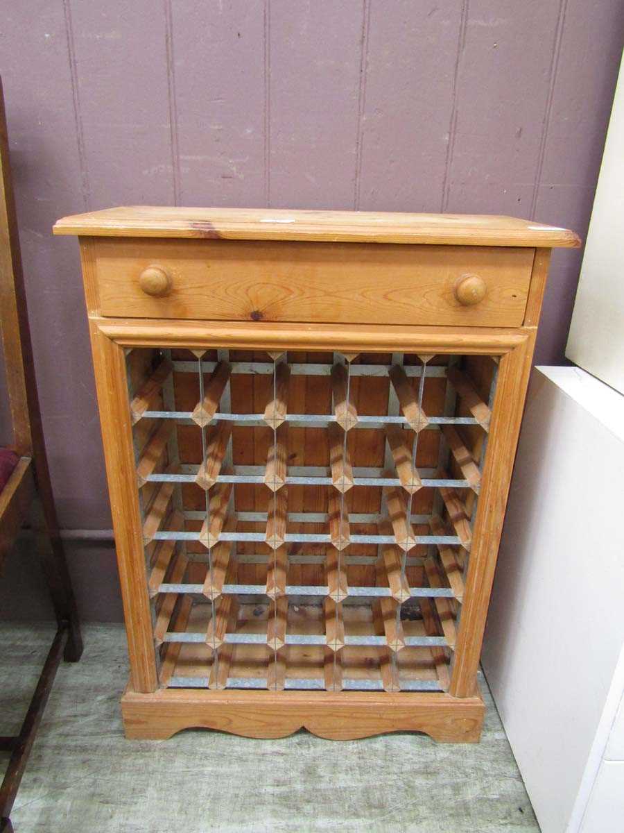 A waxed pine cabinet having single drawer above metalwork wine rack