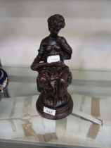 A reproduction moulded model of lady reading book