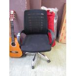 A modern black upholstered executive chair with chromed support