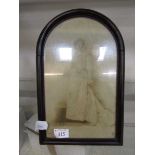 An arch topped easel photo frame with photo of young lady
