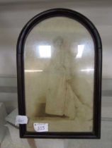 An arch topped easel photo frame with photo of young lady