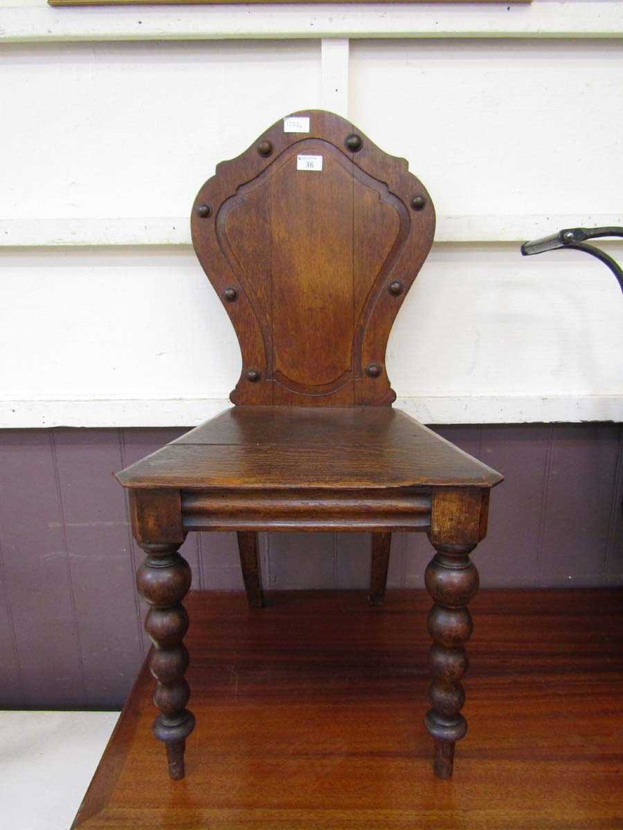 A late Victorian oak shield back hall chair