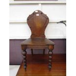 A late Victorian oak shield back hall chair