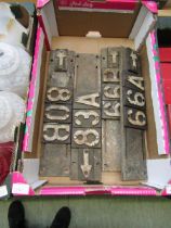 A tray containing four early 20th century cast metal railway signs