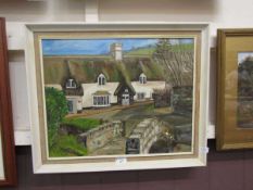 A framed oil on board of cottage scene