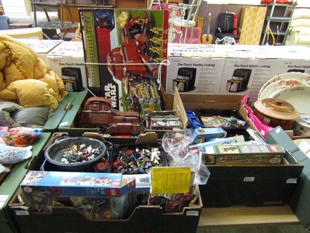Three trays containing a large assortment of LEGO and boxes to include LEGO Star Wars, LEGO City,