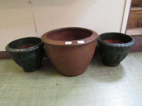 A pair of green glazed garden pots together with a brown glazed large pot