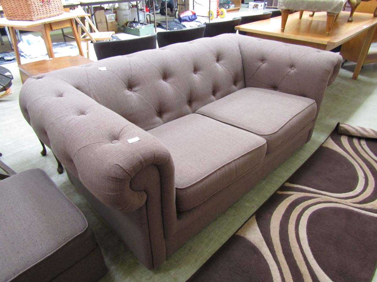 A modern brown upholstered Chesterfield style sofa