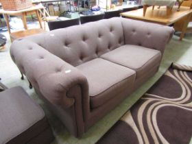 A modern brown upholstered Chesterfield style sofa