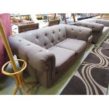 A modern brown upholstered Chesterfield style sofa