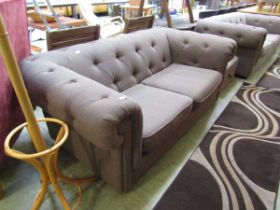 A modern brown upholstered Chesterfield style sofa