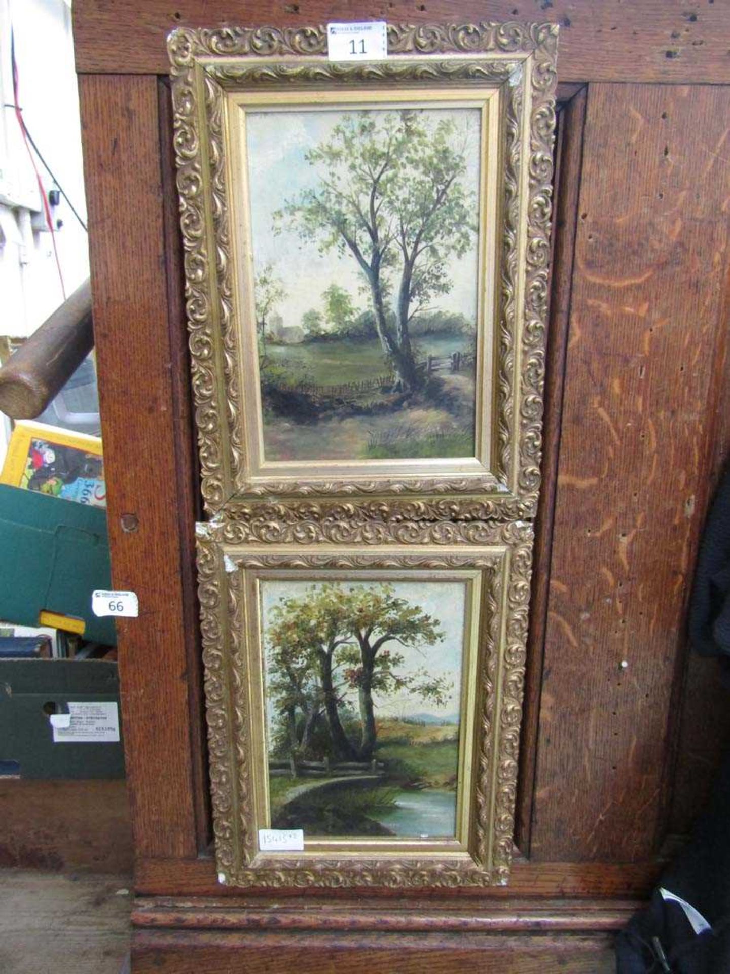 A pair of ornate gilt framed oils on board of countryside scenes