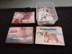 A PVC box containing an assortment of cigarette card albums with contents