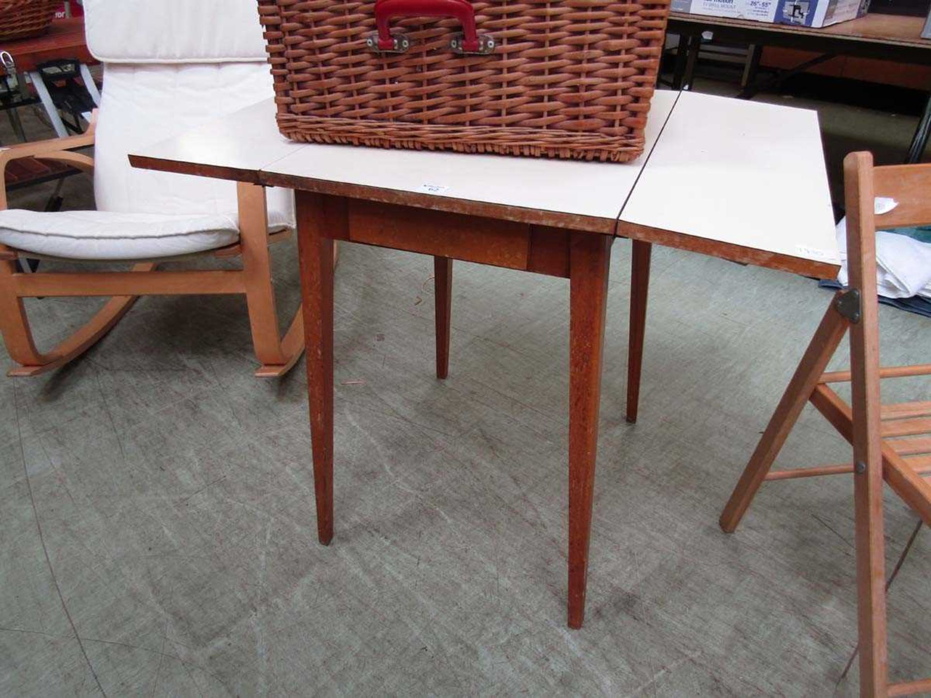 A mid-20th century Formica topped drop-leaf kitchen table