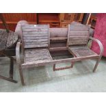 A distressed wooden garden twin seat (A/F)