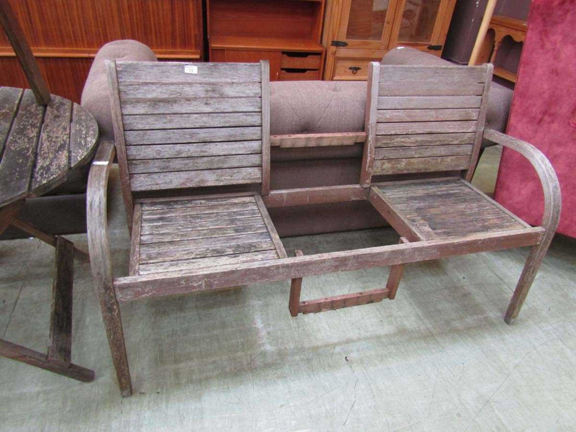 A distressed wooden garden twin seat (A/F)