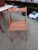 A beech folding slatted seated chair