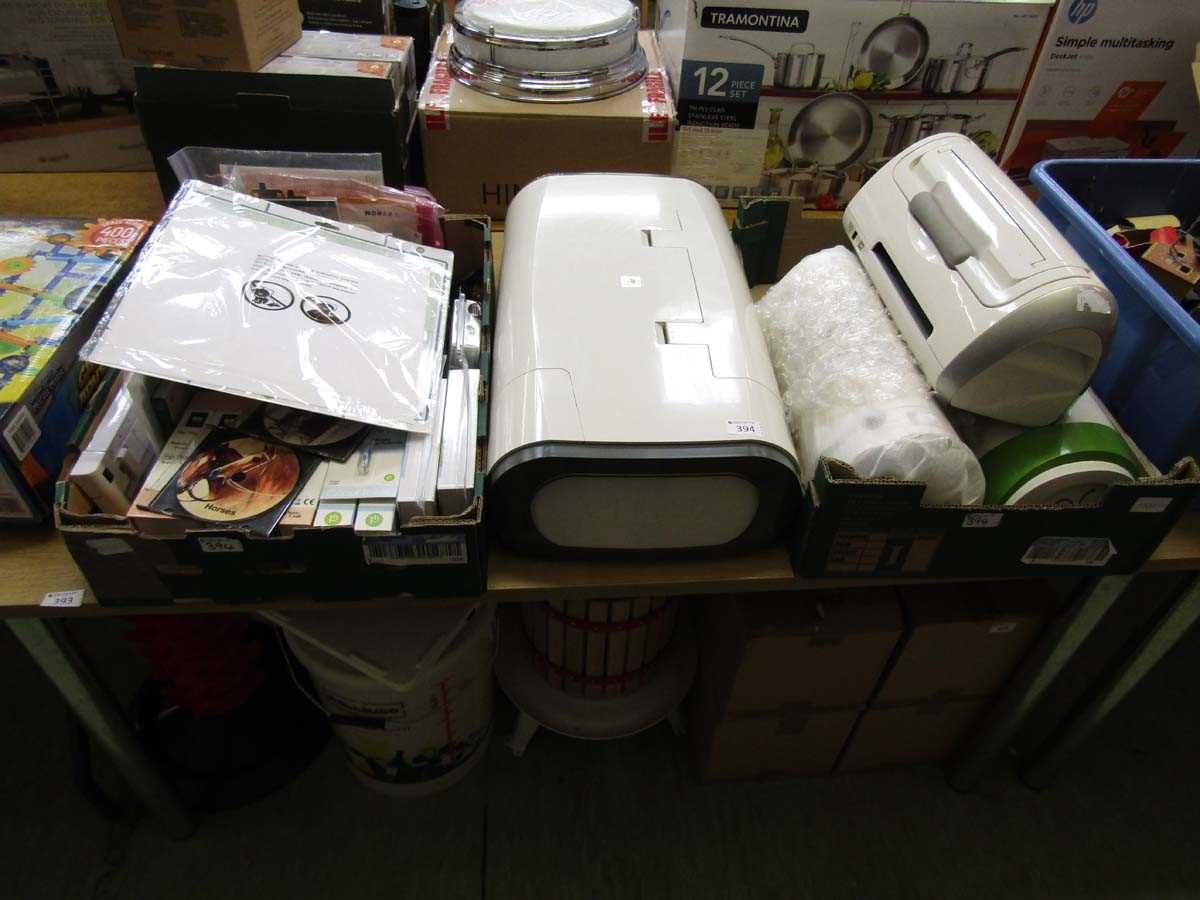 Two trays containing four Cricut machines and accessories
