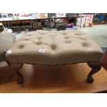 A cream leather upholstered footstool on cabriole supports