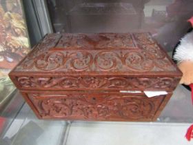 A carved wooden workbox