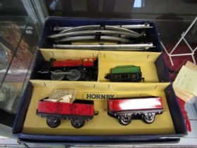 A Hornby clockwork train set consisting of engine, tender, two carriages, and a selection of track