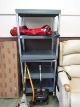 A grey PVC shelving unit on wheels along with one other without wheels