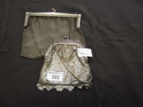 A white metal chainmail purse along with one other white metal purse