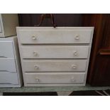 A cream painted chest of four drawers