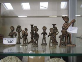 A collection of miniature African style cast brass figures of people