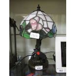 A small reproduction Tiffany style table lamp