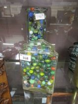 Two glass jars containing coloured marbles