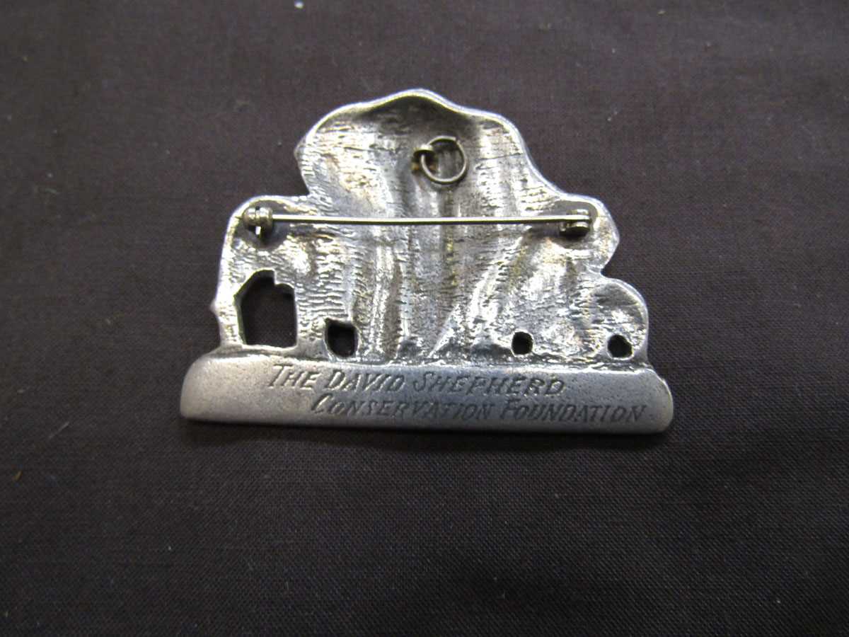 A white metal brooch of elephants with inscription to back 'The David Shepherd Conservation - Image 2 of 2