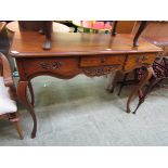 A reproduction walnut console table having three drawers on cabriole supports Dimensions: H,