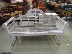 A white painted Lutyens style garden bench