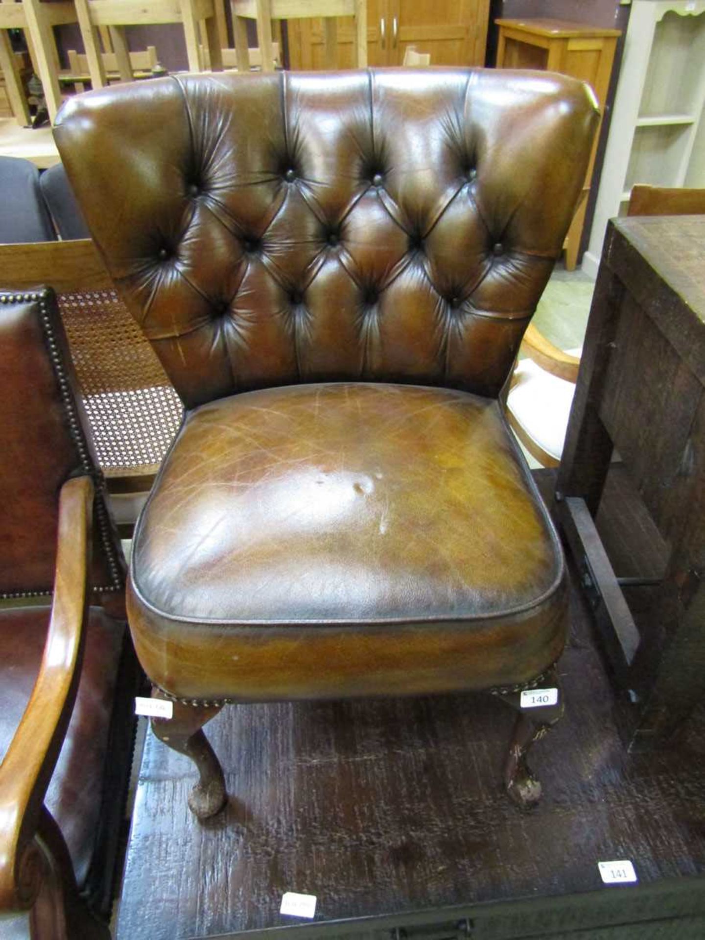 A child's reproduction early 20th century leather upholstered chair