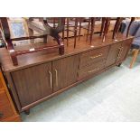 A reproduction mid-20th century design sideboard having two drawers flanked by cupboard doors