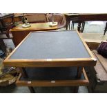 A mid-20th century teak low level table with slate top