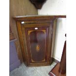 A Georgian inlaid oak wall mounted corner cupboard