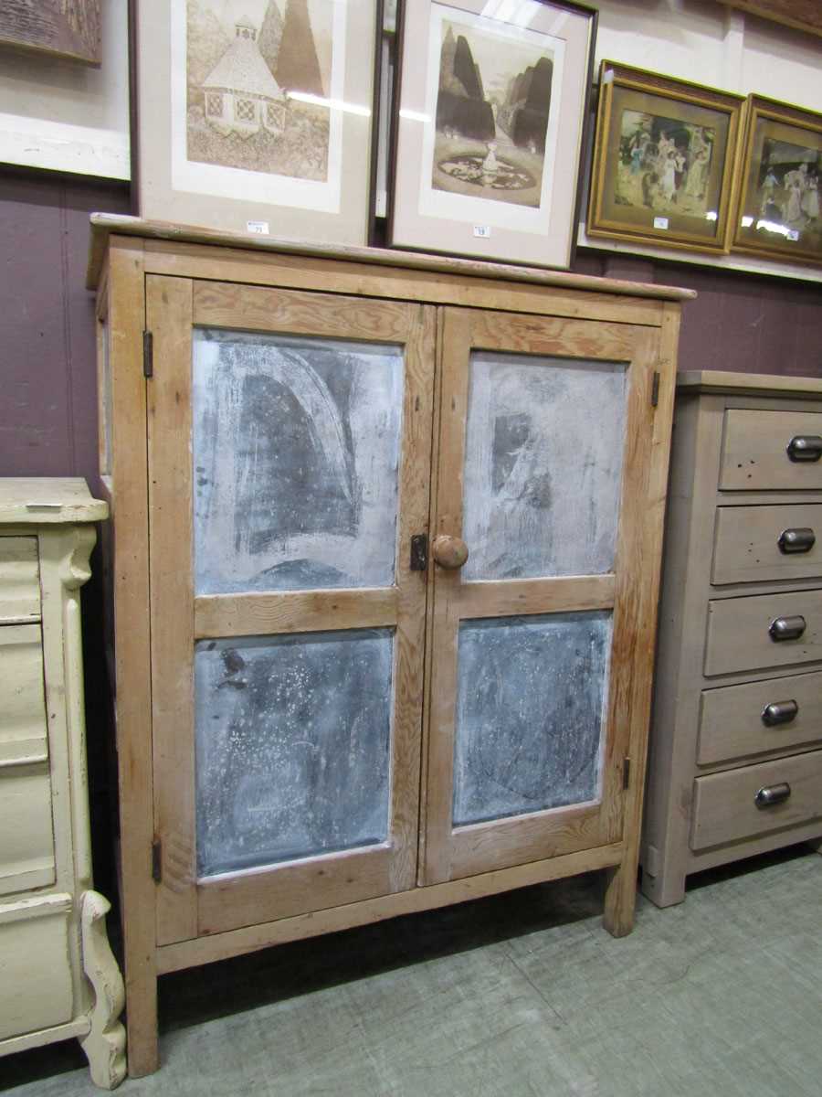A French stripped pine two door cabinet