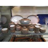 An assortment of Denby 'Greystone' tableware to include meat plates, tureen, cups, saucers, etc